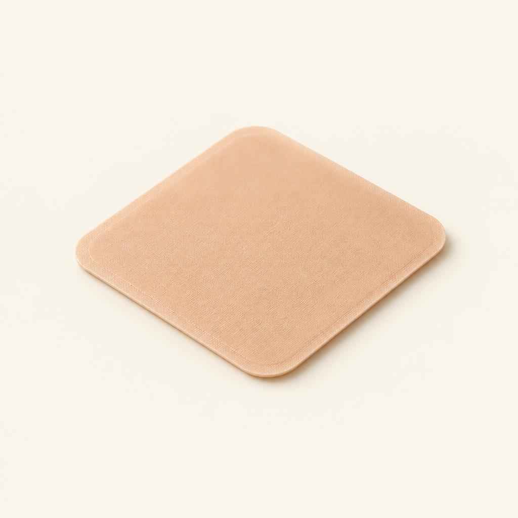 Plain square skin-tone patch on a cream background